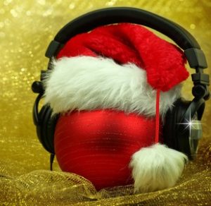 34457604 - christmas ball with headphones in glittering background